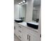 Bathroom featuring dual vanities, marble countertops, and modern black fixtures and hardware at 3204 W Grace St, Tampa, FL 33607