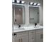 Bathroom featuring double vanities, elegant tile flooring, and modern fixtures at 3204 W Grace St, Tampa, FL 33607