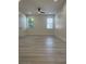 Light-filled room with recessed lights, fan, and two windows with blinds and wood-look flooring at 3204 W Grace St, Tampa, FL 33607