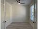 Bright bedroom boasts wood-look flooring, neutral paint, ceiling fan, and a window at 3204 W Grace St, Tampa, FL 33607