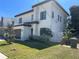 Stylish home featuring a modern design with a dark garage door, stone accents, and beautiful landscaping at 3204 W Grace St, Tampa, FL 33607