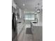 Galley kitchen boasts marble countertops, stainless appliances, a center island with a sink and modern finishes at 3204 W Grace St, Tampa, FL 33607