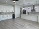 Modern kitchen features white cabinets, a large island, stainless steel appliances, and stylish pendant lighting at 3204 W Grace St, Tampa, FL 33607