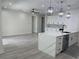 Light and bright open-concept living room with wood-look flooring and neutral paint at 3204 W Grace St, Tampa, FL 33607
