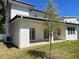 A covered patio with sliding doors creates an ideal indoor/outdoor living space with a view of the yard at 3204 W Grace St, Tampa, FL 33607