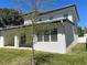 A spacious covered patio with sliding doors creates an ideal indoor/outdoor space and enhances the yard at 3204 W Grace St, Tampa, FL 33607