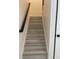 Neutral stairway with a black handrail and white risers for a clean, modern look at 3204 W Grace St, Tampa, FL 33607