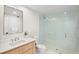 Bright bathroom features a modern vanity, a large mirror, and a glass-enclosed shower at 322 Beach Rd, Sarasota, FL 34242