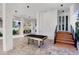 Open ground level space features a pool table and staircase, perfect for entertaining or relaxing in a shaded outdoor setting at 322 Beach Rd, Sarasota, FL 34242