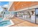 Bright living space features hardwood floors, modern decor, and an outdoor pool deck with lounge chairs at 322 Beach Rd, Sarasota, FL 34242