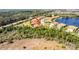 Aerial view of a home and community backing up to a wooded area and a retention pond at 324 Casalino Dr, Nokomis, FL 34275