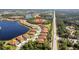 Aerial view of a home and community with mature landscaping and nearby lake at 324 Casalino Dr, Nokomis, FL 34275
