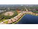 Aerial view of a home and community near a lake, surrounded by nature at 324 Casalino Dr, Nokomis, FL 34275