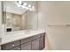 Bathroom showcasing a gray vanity with a white countertop and a large mirror with vanity lighting at 324 Casalino Dr, Nokomis, FL 34275