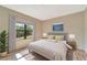 A serene bedroom features a large window with natural light, hardwood floors and stylish decor at 324 Casalino Dr, Nokomis, FL 34275