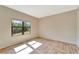Sunlit bedroom with herringbone pattern floors, large window with beautiful outdoor view at 324 Casalino Dr, Nokomis, FL 34275