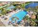 Relax by the large community pool with palm trees, lounge chairs and cabanas near the tennis courts at 324 Casalino Dr, Nokomis, FL 34275