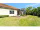 Home exterior featuring a screened lanai, green lawn and mature landscaping at 324 Casalino Dr, Nokomis, FL 34275