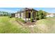 Home exterior showcasing a screened lanai, lush lawn and beautiful landscaping at 324 Casalino Dr, Nokomis, FL 34275