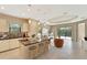 An open-concept kitchen boasts modern appliances, a breakfast bar, and seamless flow into the living area at 324 Casalino Dr, Nokomis, FL 34275