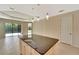 Open concept kitchen area with a large island and easy access to outdoor living spaces at 324 Casalino Dr, Nokomis, FL 34275