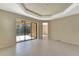 Open living space with tile floors and a large sliding glass door leading to outdoor patio at 324 Casalino Dr, Nokomis, FL 34275