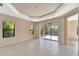 A bright living room featuring large windows and sliding glass doors, offering ample natural light and access to outdoor space at 324 Casalino Dr, Nokomis, FL 34275
