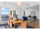 Open-concept dining area with water views, modern lighting, and access to the living room at 35 Watergate Dr # 1402, Sarasota, FL 34236