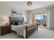 Comfortable bedroom boasts a cozy bed, nightstands, and balcony access at 35 Watergate Dr # 1402, Sarasota, FL 34236
