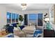 Bright living room with floor-to-ceiling windows, comfortable seating, and amazing views at 35 Watergate Dr # 1402, Sarasota, FL 34236