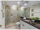Elegant bathroom featuring a glass shower and dark granite counters at 35 Watergate Dr # 1402, Sarasota, FL 34236