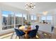 Bright dining room with hardwood floors, modern chandelier, and stunning city and water views at 35 Watergate Dr # 1402, Sarasota, FL 34236