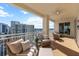 This balcony features cushioned seating and views of the city and bay at 35 Watergate Dr # 1402, Sarasota, FL 34236