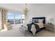 Bright bedroom with a large window, blue accents, and views of the city and water at 35 Watergate Dr # 1402, Sarasota, FL 34236