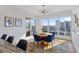 Bright dining room with hardwood floors, modern chandelier, and large windows showcasing city views at 35 Watergate Dr # 1402, Sarasota, FL 34236