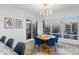 Bright dining room with modern light fixture, and views of the city and water at 35 Watergate Dr # 1402, Sarasota, FL 34236