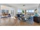 An open concept living and dining area with hardwood floors, large windows, and a balcony at 35 Watergate Dr # 1402, Sarasota, FL 34236