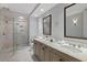 Bright bathroom featuring a walk-in shower, dual vanity, and elegant marble flooring at 35 Watergate Dr # 1402, Sarasota, FL 34236