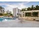 Relaxing poolside patio with modern fire pit and outdoor seating, creating a cozy and inviting atmosphere at 35 Watergate Dr # 1402, Sarasota, FL 34236