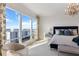 Bright bedroom featuring waterfront views from floor-to-ceiling windows and stylish chandelier at 35 Watergate Dr # 1402, Sarasota, FL 34236