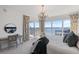 Bright bedroom with a large window, blue accents, and views of the city and water at 35 Watergate Dr # 1402, Sarasota, FL 34236
