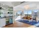 Elegant dining room features a stylish bar area, modern chandelier, and city views at 35 Watergate Dr # 1402, Sarasota, FL 34236