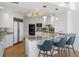 Elegant white kitchen with granite countertops, stainless steel appliances, and a breakfast bar at 35 Watergate Dr # 1402, Sarasota, FL 34236