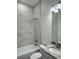 Bright bathroom with white marble tile, updated fixtures, and vanity with granite countertop at 3525 Mcintosh Rd, Sarasota, FL 34232