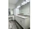 Bathroom featuring double sinks, a vanity area and custom cabinets at 3525 Mcintosh Rd, Sarasota, FL 34232