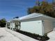 Well maintained home featuring a metal roof, manicured landscaping, and a one-car garage at 3525 Mcintosh Rd, Sarasota, FL 34232