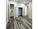 Hallway features wood-look floors, white doors and trim, and multiple closets for storage at 3525 Mcintosh Rd, Sarasota, FL 34232