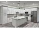 Bright kitchen with stainless steel appliances, island, and custom cabinets at 3525 Mcintosh Rd, Sarasota, FL 34232