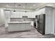 Bright kitchen with stainless steel appliances, island, and custom cabinets at 3525 Mcintosh Rd, Sarasota, FL 34232