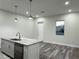 Well-lit kitchen showcases a large island with a stainless steel dishwasher and modern pendant lighting at 3525 Mcintosh Rd, Sarasota, FL 34232
